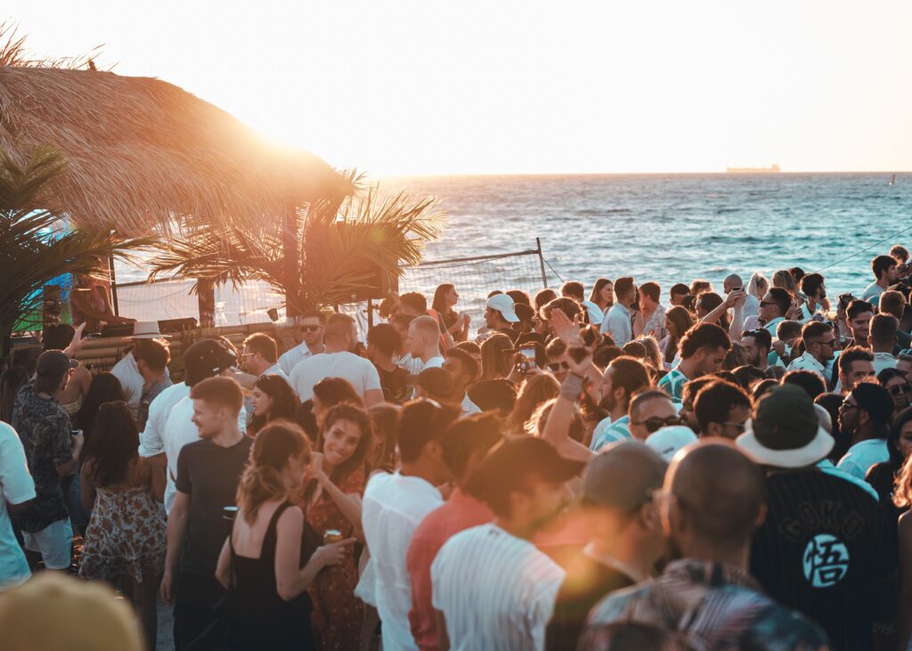 pexels-photo-11653917-11653917 Crowd enjoying a vibrant beach party with stunning sunset views in Australia.
